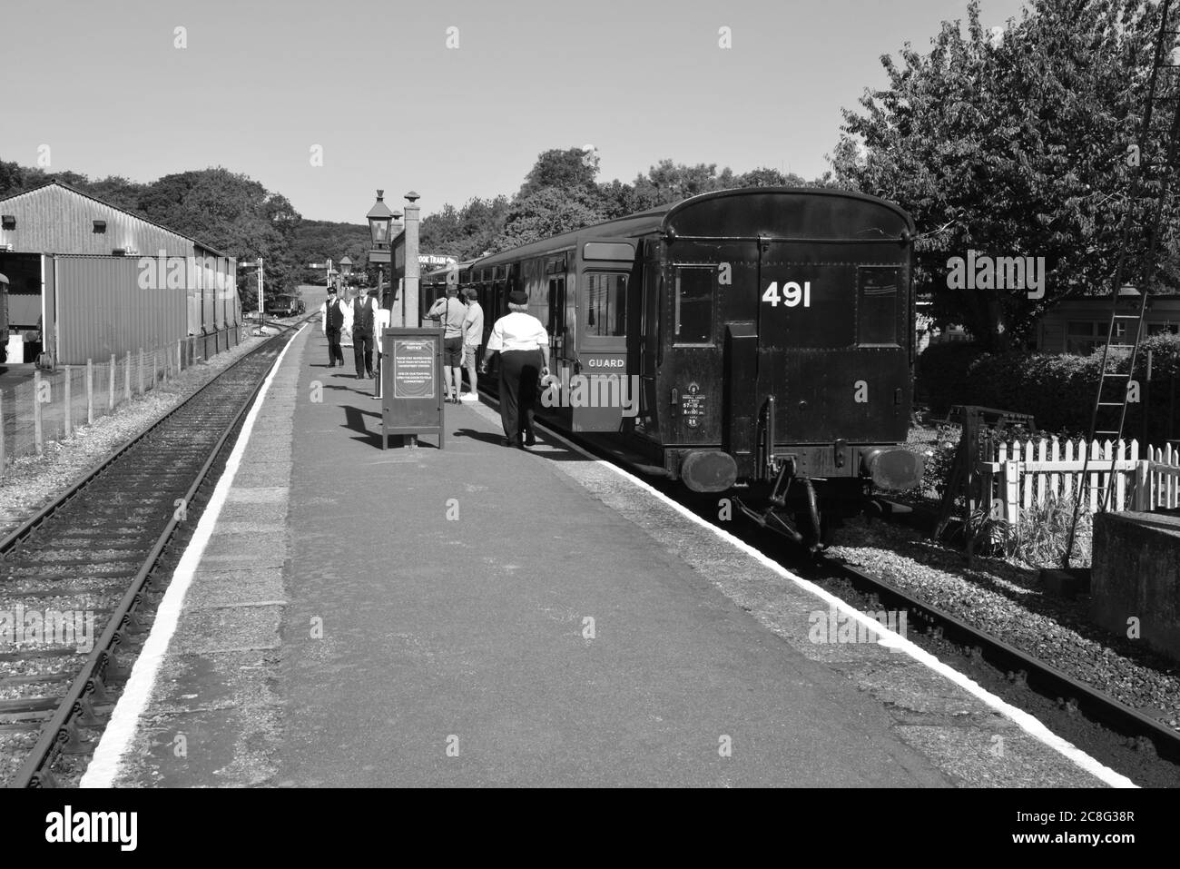 Passenger getting on a train at Haven station in the Isle of Wight. Stock Photo
