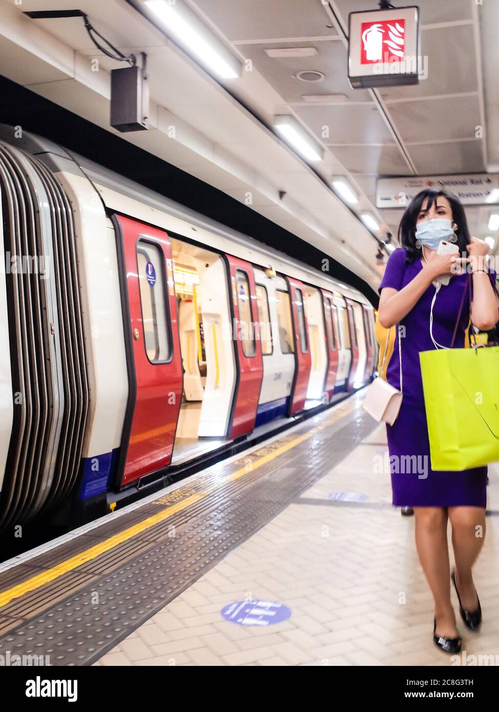 Woman shopper wearing face mask on the London Underground Stock Photo