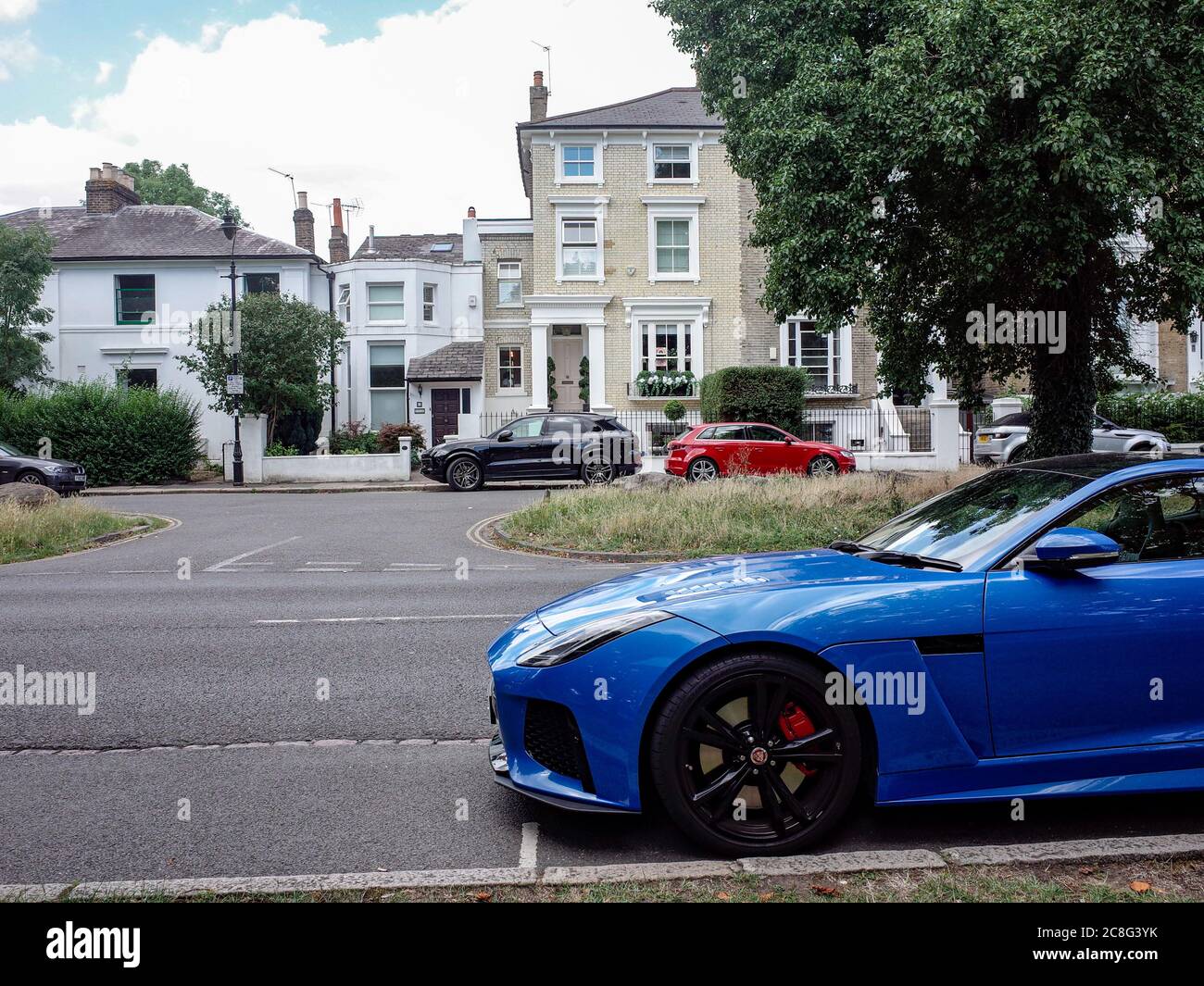 Attractive and upmarket residential street in Ealing, West London with large houses and an expensive car Stock Photo