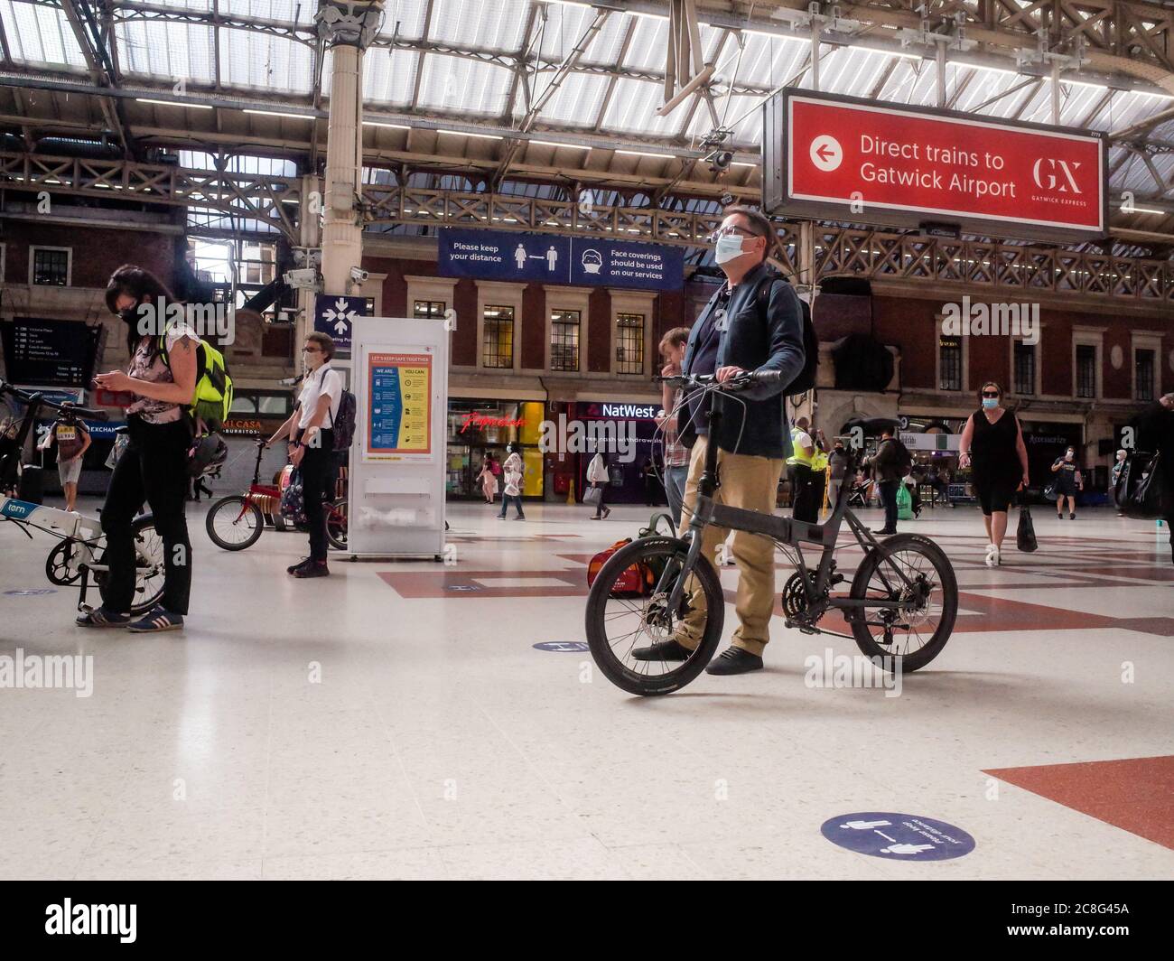 Commuters wearing face masks inside Victoria Station London Stock Photo Alamy