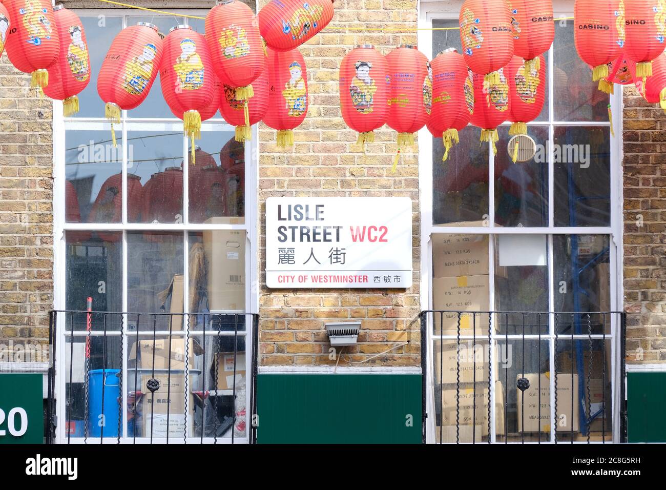 Lisle Street street sign with a row of red lanterns hanging above. The street is at the heart of Chinatown lines with restaurants. Stock Photo