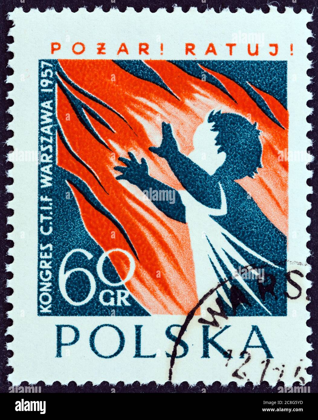 POLAND - CIRCA 1957: A stamp printed in Poland issued for the International Fire Brigades Conference, Warsaw shows flames enveloping child, circa 1957. Stock Photo