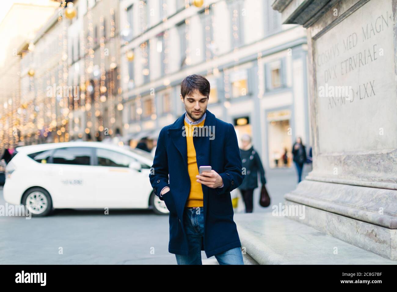 Man using smartphone at piazza, Firenze, Toscana, Italy Stock Photo