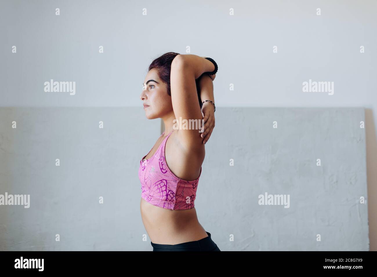 Woman doing stretching exercise at home Stock Photo