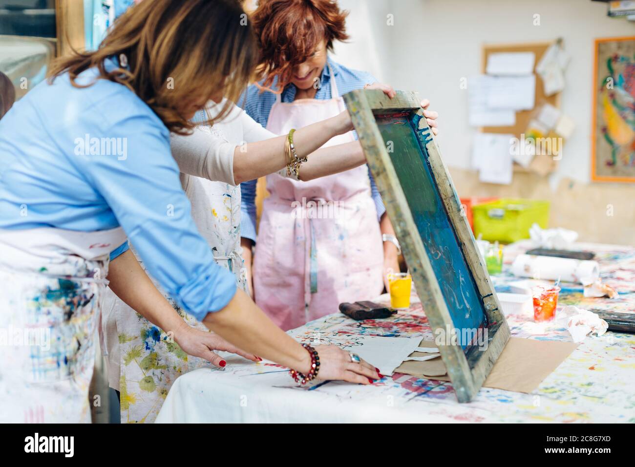 Artist teaching silk screen printing in creative studio Stock Photo
