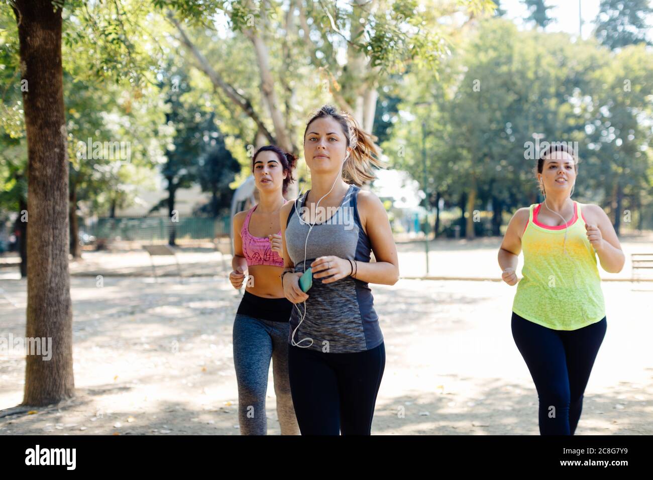 Friends jogging in park Stock Photo