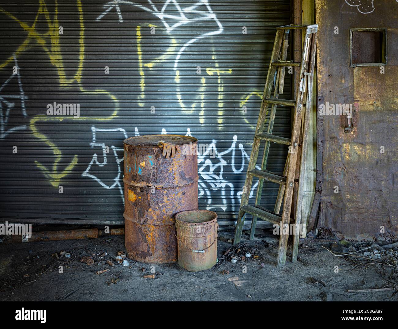 Rusty oil drum and ladder, abandoned industrial building, Conshohocken, Pennsylvania, USA Stock Photo