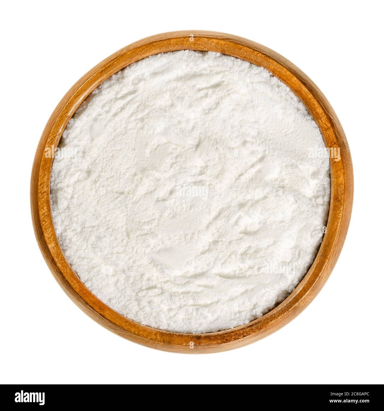 Baking powder in wooden bowl. White, dry chemical leavening agent. Mixture of carbonate or bicarbonate and weak acid. Stock Photo
