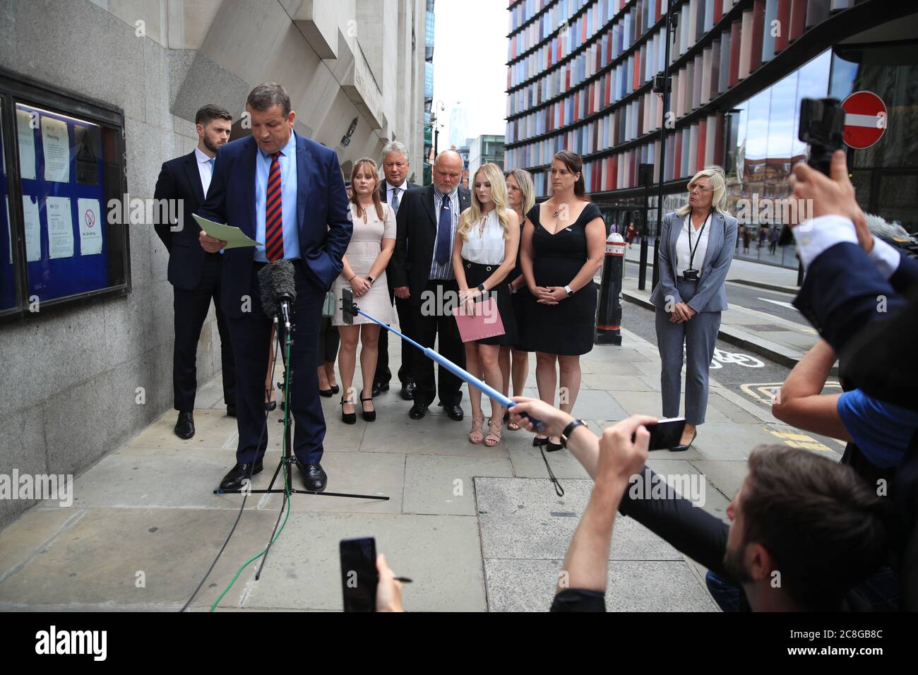 Thames Valley Police Senior Investigating Officer, Detective Superintendent Stuart Blaik, is watched by Lissie Harper (third right), the widow of Pc Andrew Harper, as he speaks to the media outside the Old Bailey in London, after driver Henry Long, 19, who dragged Pc Andrew Harper to his death, was found not guilty of murder but had earlier pleaded guilty to manslaughter and his passengers Jessie Cole and Albert Bowers, both 18, were cleared of murder but found guilty of manslaughter. Stock Photo