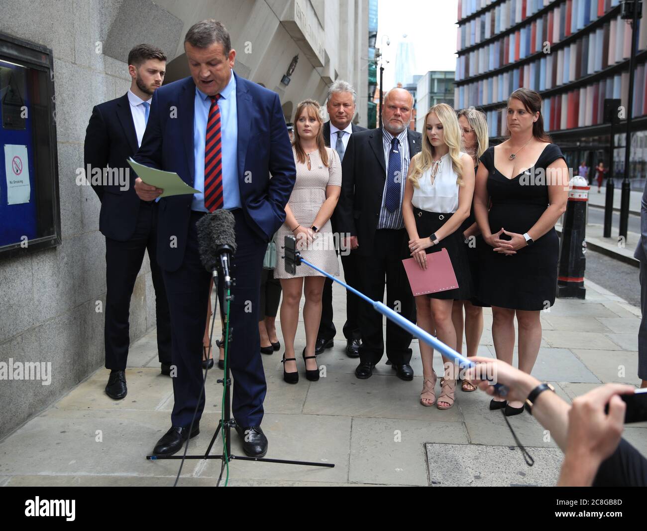 Thames Valley Police Senior Investigating Officer, Detective Superintendent Stuart Blaik, is watched by Lissie Harper (second right), the widow of Pc Andrew Harper, as he speaks to the media outside the Old Bailey in London, after driver Henry Long, 19, who dragged Pc Andrew Harper to his death, was found not guilty of murder but had earlier pleaded guilty to manslaughter and his passengers Jessie Cole and Albert Bowers, both 18, were cleared of murder but found guilty of manslaughter. Stock Photo