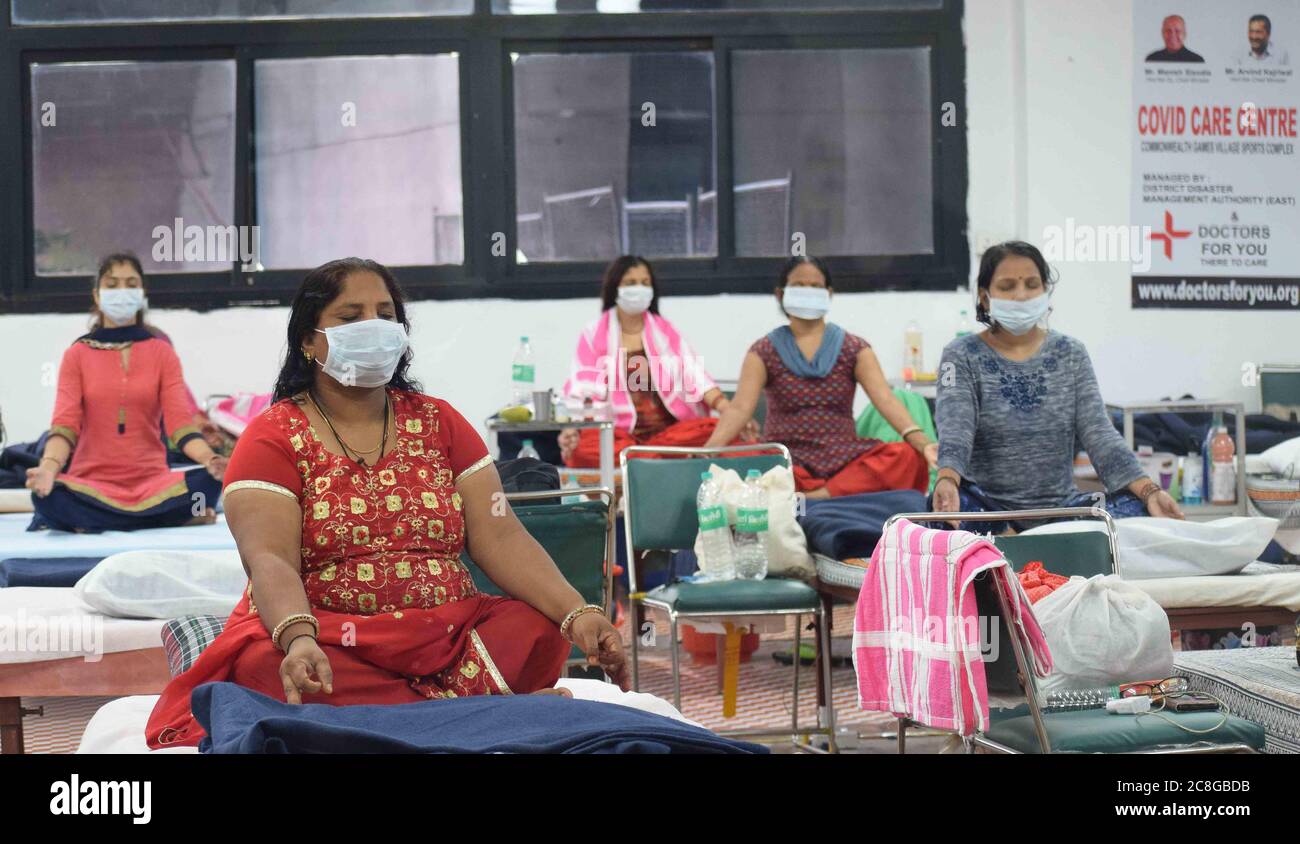 New Delhi, India. 24th July, 2020. Patients suffering from coronavirus infection attend a yoga class inside a ward at the Commonwealth Games Village sports complex COVID centre in New Delhi, India on Friday July 24, 2020. Doctors For You, a not-for-profit organisation, supported the Delhi government in setting up the facility which has a capacity of 500 beds. (Photo by Sondeep Shankar/Pacific Press/Sipa USA) Credit: Sipa USA/Alamy Live News Stock Photo