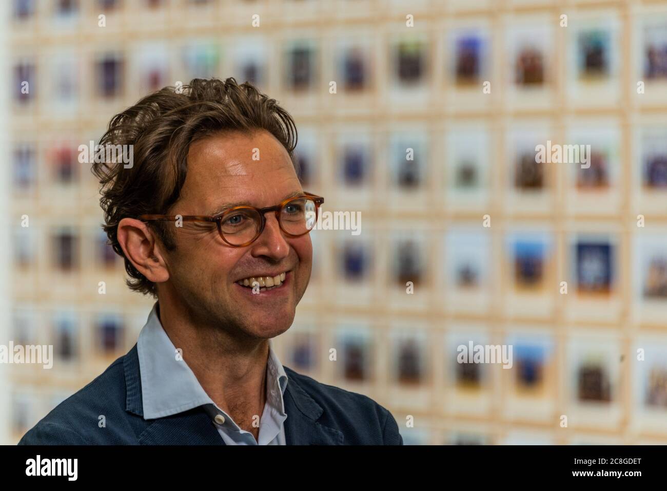 London, UK. 24th July, 2020. Alex Farquharson, director of Tate Britain, is happy to be back as he is interviewed in front of Steve McQueen's Year 3 schools project in the Duveen Gallery - The Tate Britain re-opens on Monday. Visitors are asked to follow guidance on social distancing etc, in line with advice from government following the easing of the lockdown. Credit: Guy Bell/Alamy Live News Stock Photo