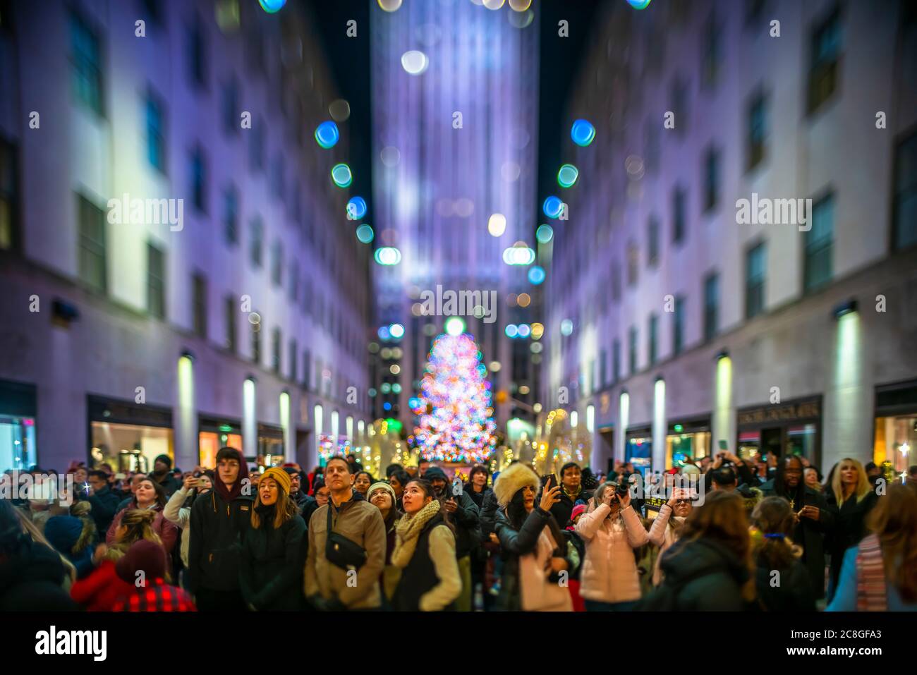 Crowd of people watch the SAKS Fifth Avenue Christmas Light Show Stock