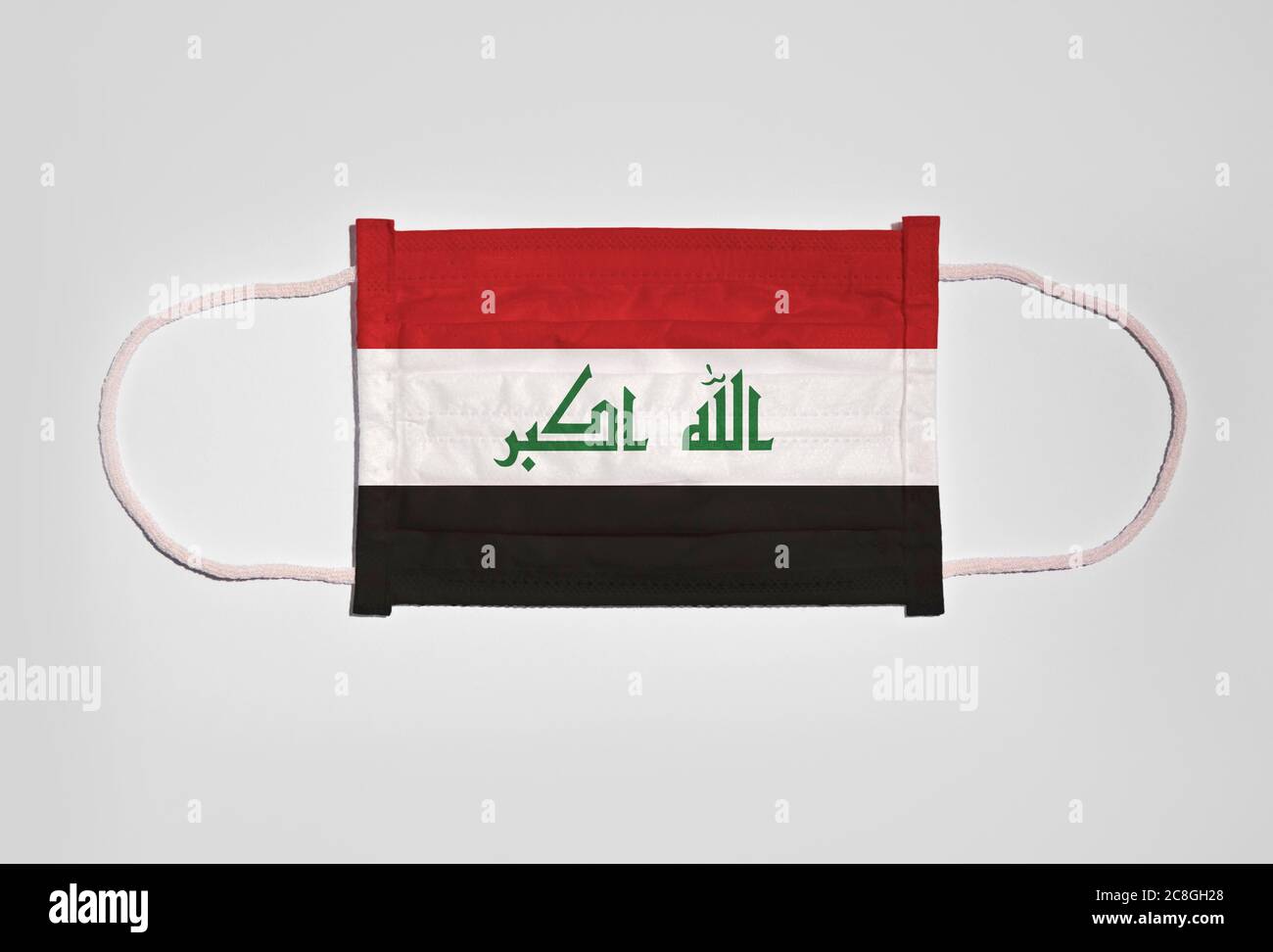 Symbol picture Corona crisis, mouth guard, breathing mask, mouth and nose guard with flag of Iraq, white background Stock Photo