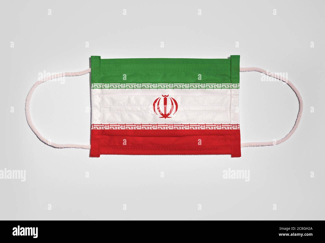 Symbol picture Corona crisis, mouth guard, breathing mask, mouth and nose guard with flag of Iran, white background Stock Photo