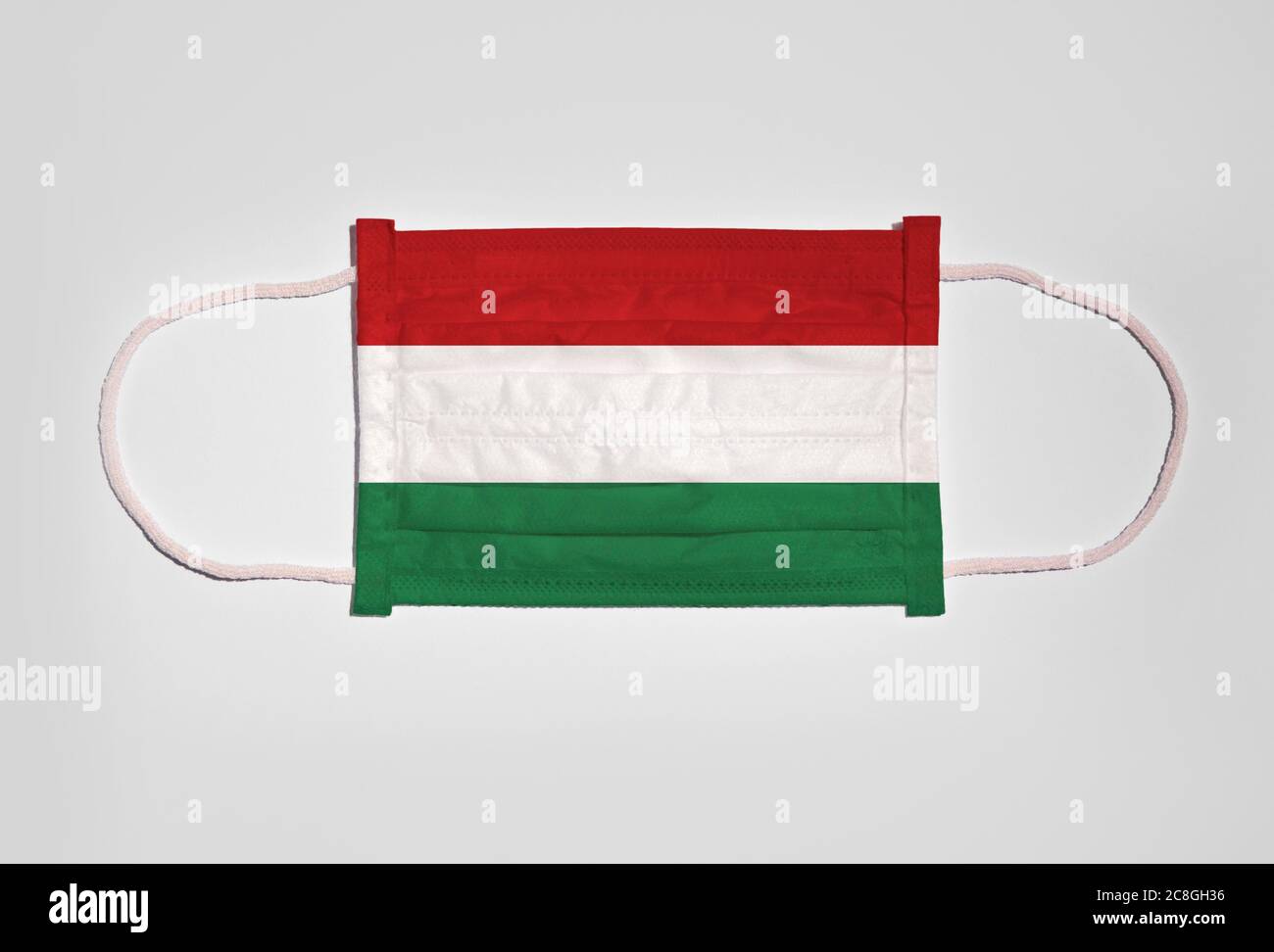 Symbol picture Corona crisis, mouth guard, breathing mask, mouth and nose guard with flag of Hungary, white background Stock Photo