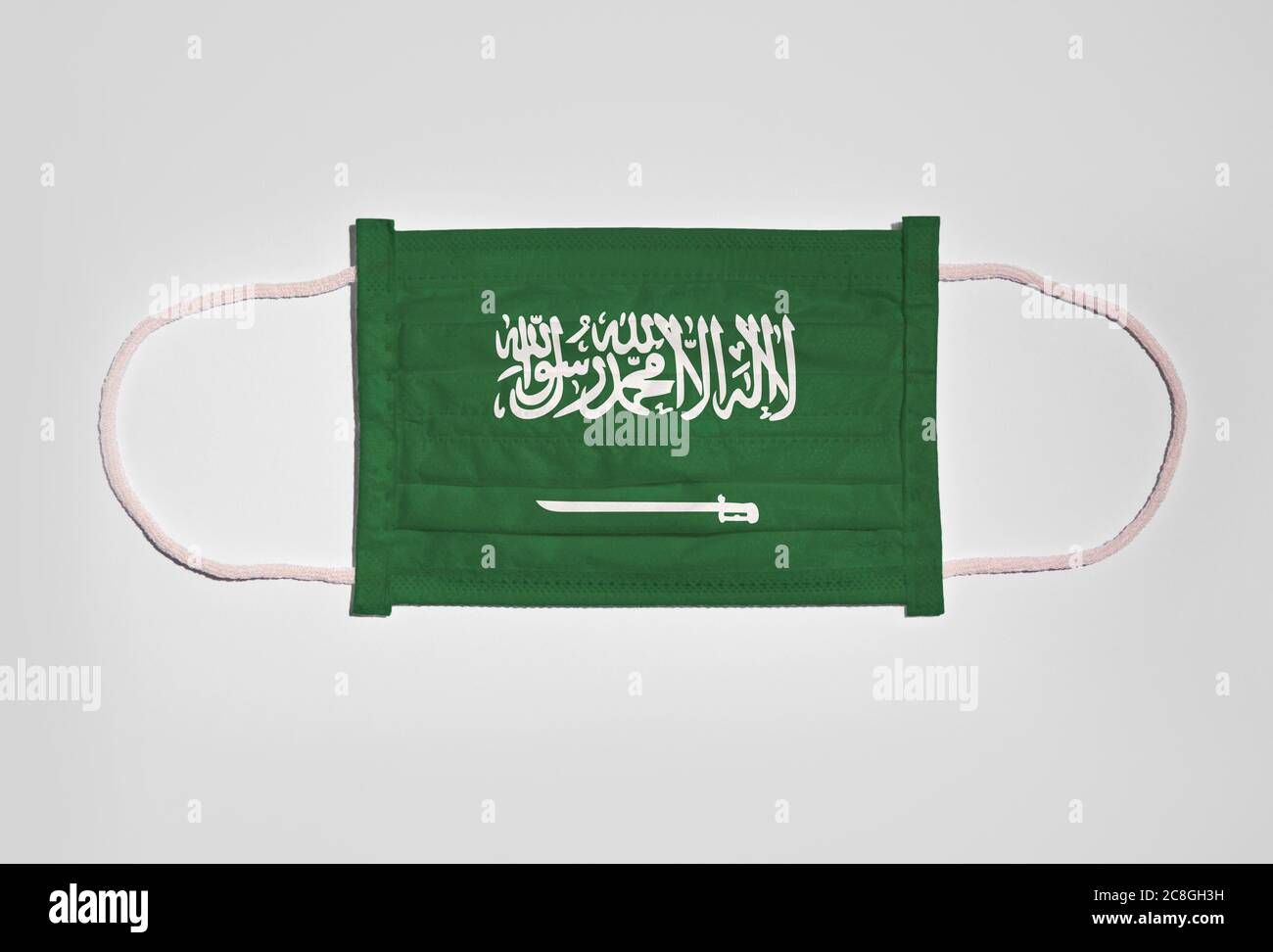 Symbol picture Corona crisis, mouth guard, breathing mask, mouth and nose guard with Saudi Arabia flag, white background Stock Photo
