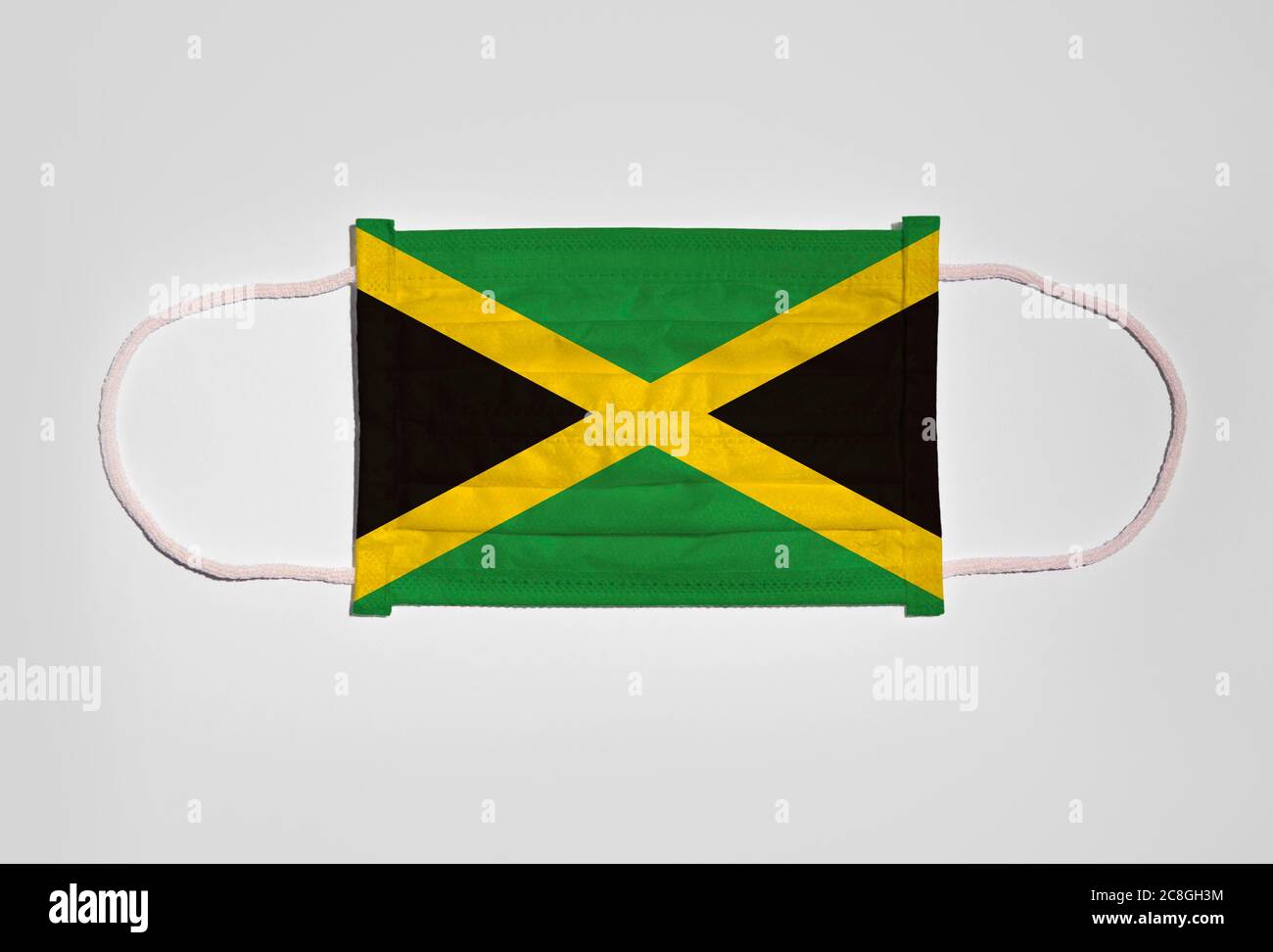 Symbol picture Corona crisis, mouth guard, breathing mask, mouth and nose guard with flag of Jamaica, white background Stock Photo