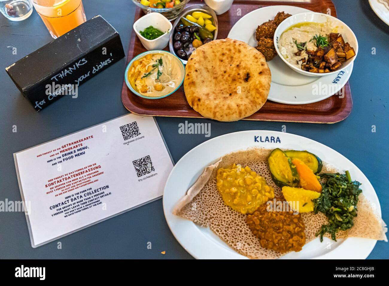 Klara Food Court during Corona Measures in Basel, Switzerland. Crossover cuisine: typical dishes from Eritrea and Israel including hygiene rules in Corona times. Stock Photo