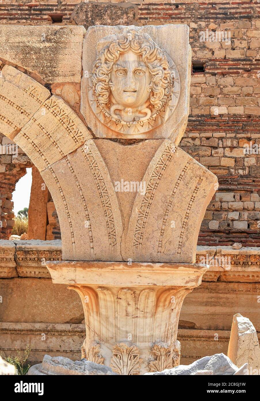Columned arch with a Medusa head, ruined city of Leptis Magna, Libya Stock Photo