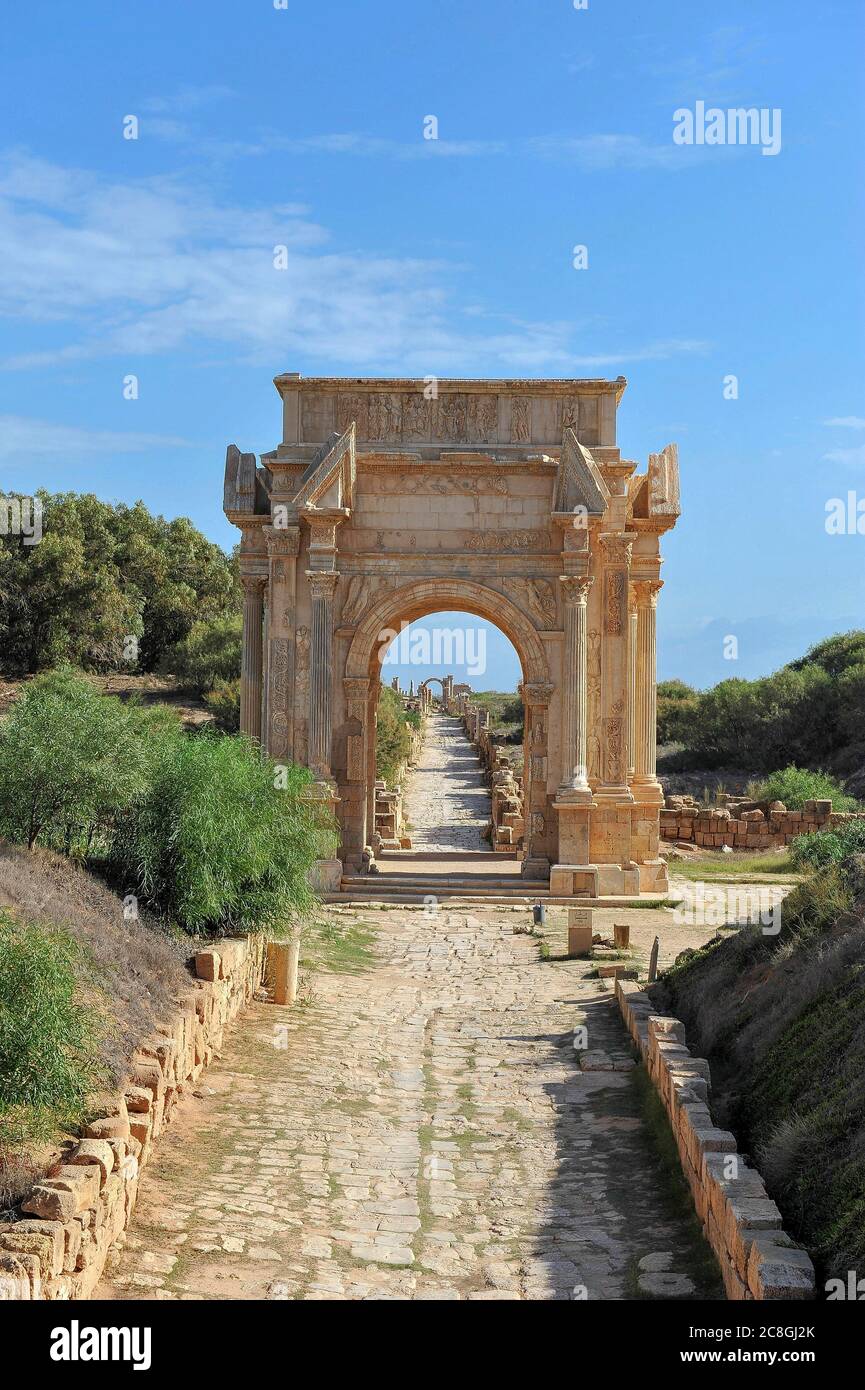 Historical street with the triumphal arch of Septimius Severus, ruined city of Leptis Magna, Libya Stock Photo