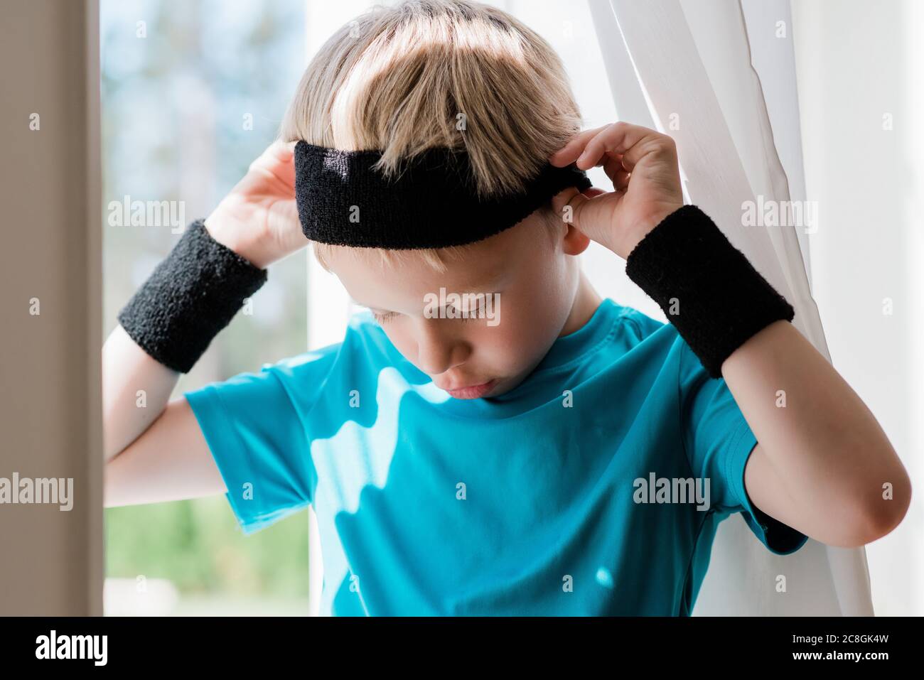 young boy with sweat bands on ready to play sport Stock Photo