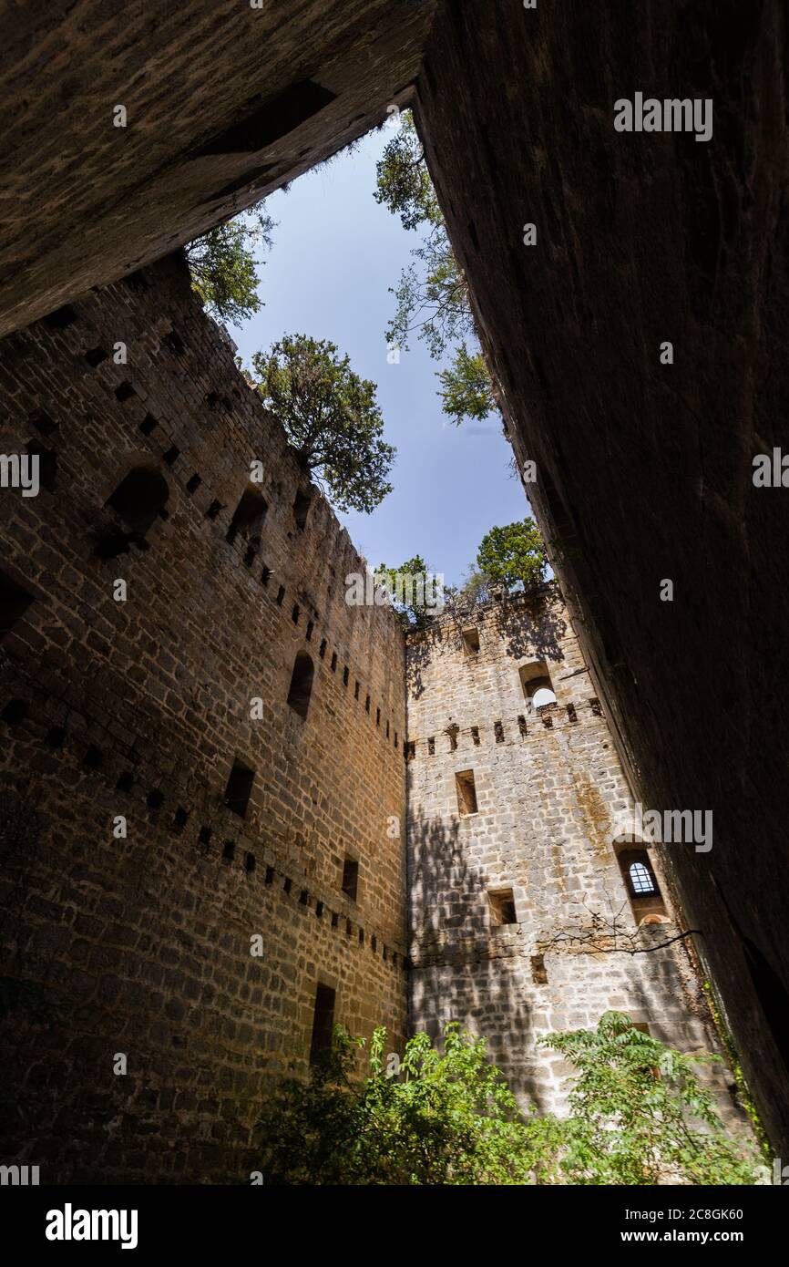 Sky and trees seen from ruinous interior Medieval tower of the V Stock Photo