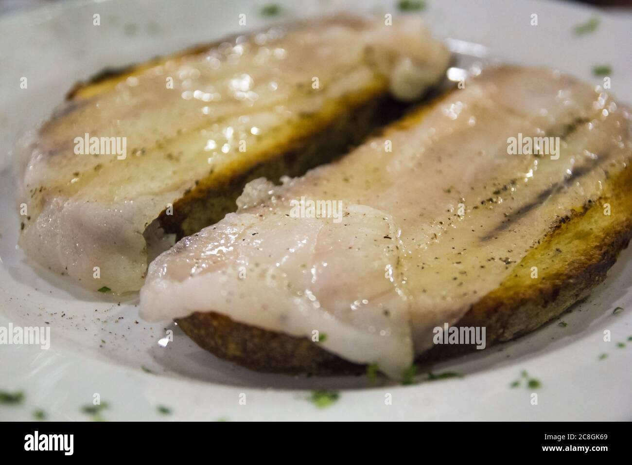 Italian bread (toasted bread) with pork lard and pepper. Traditional