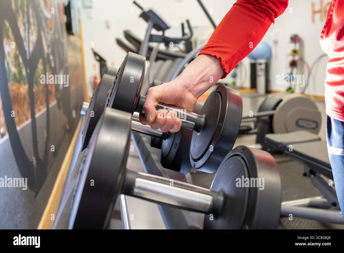 male lifting weights off of rack Stock Photo Alamy
