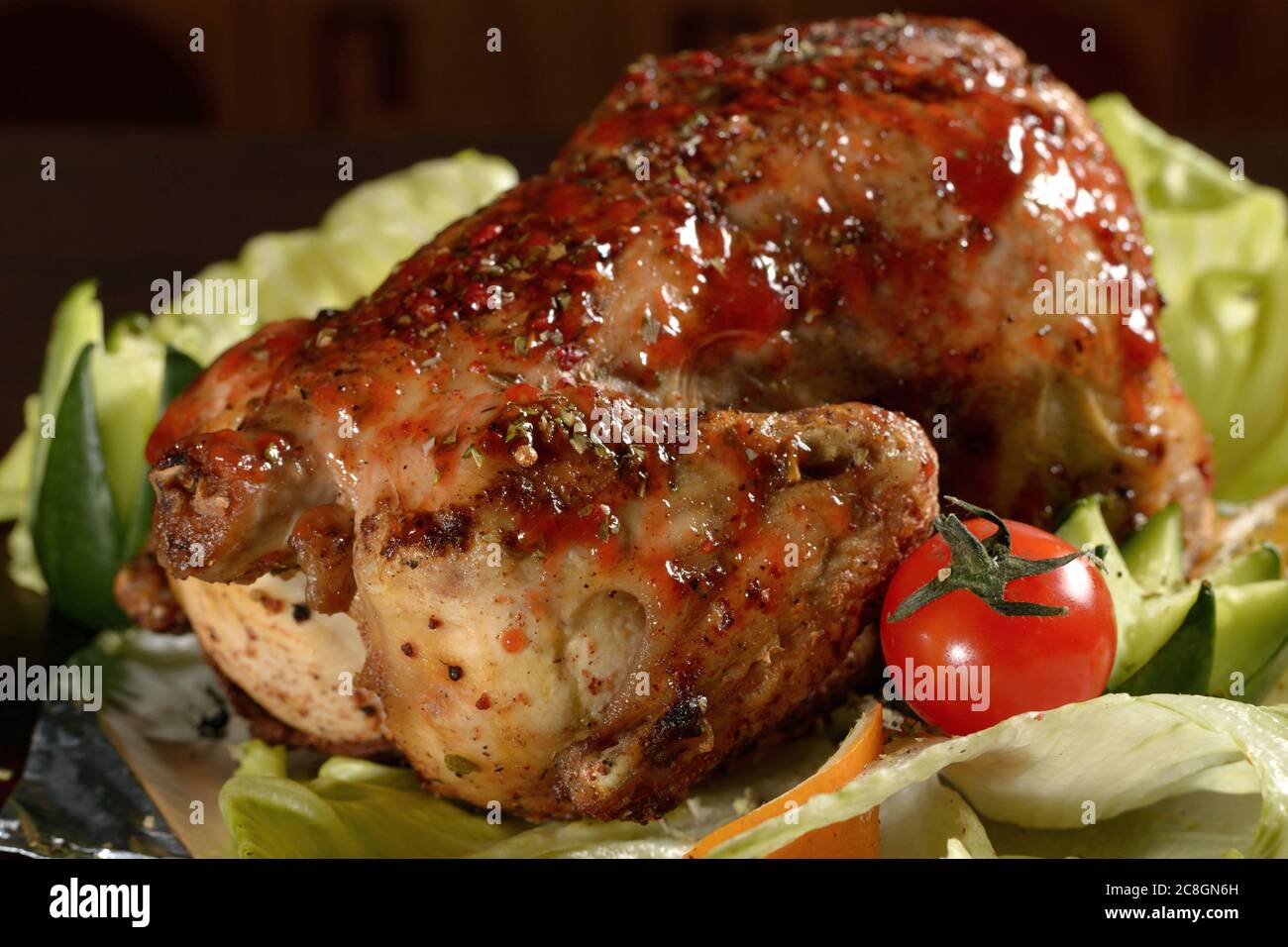 Delicious whole grilled chicken with vegetables, close up Stock Photo
