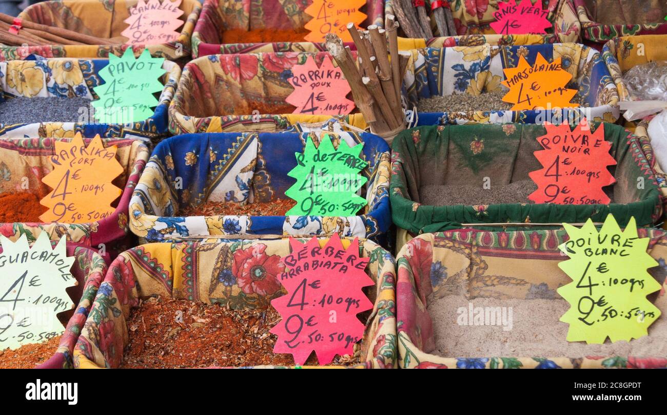 Assortment of colorful herbs and spices on display for sale in baskets at a market in Provence, France Stock Photo