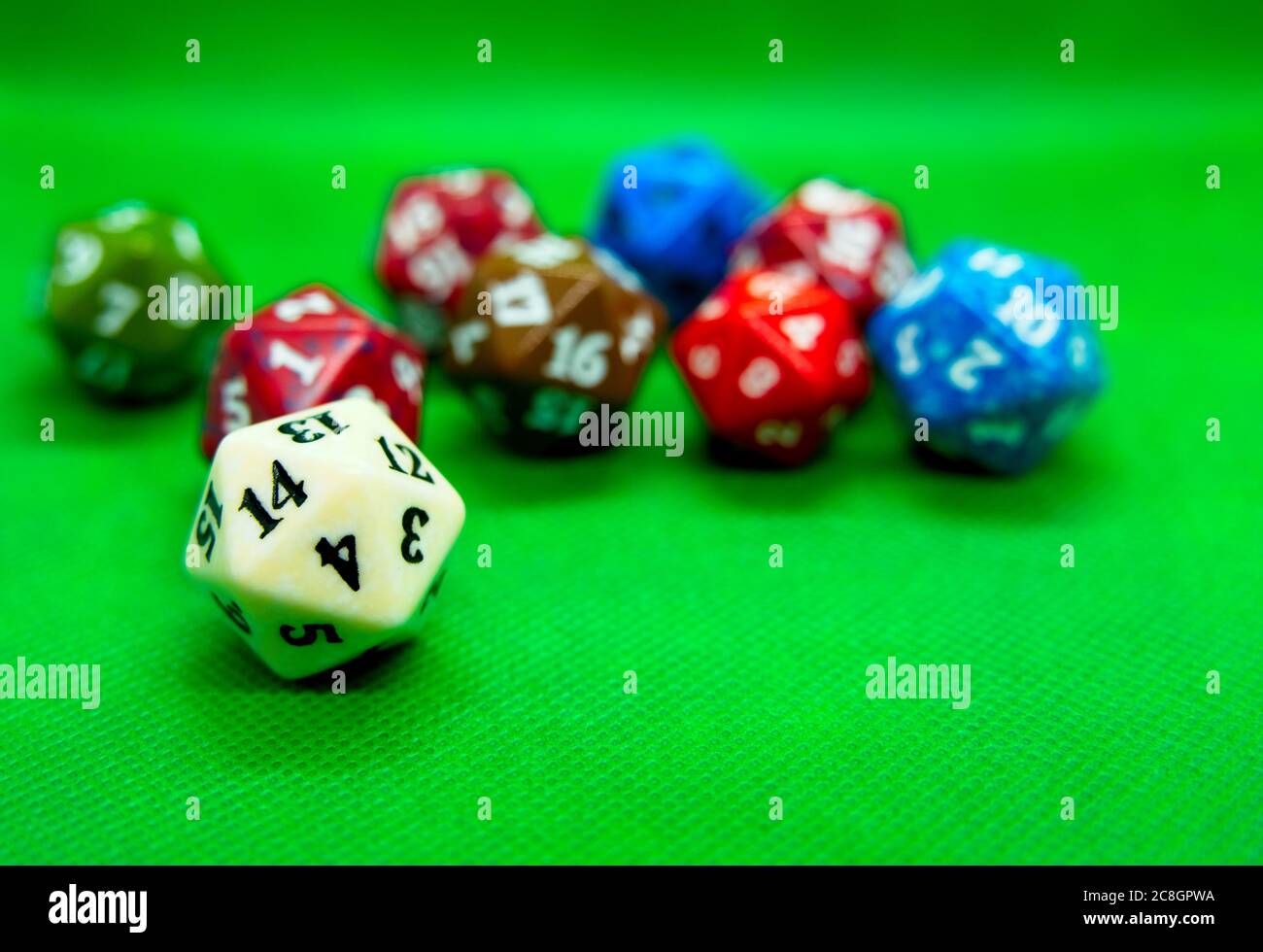 Green board with several colored role-playing dice Stock Photo