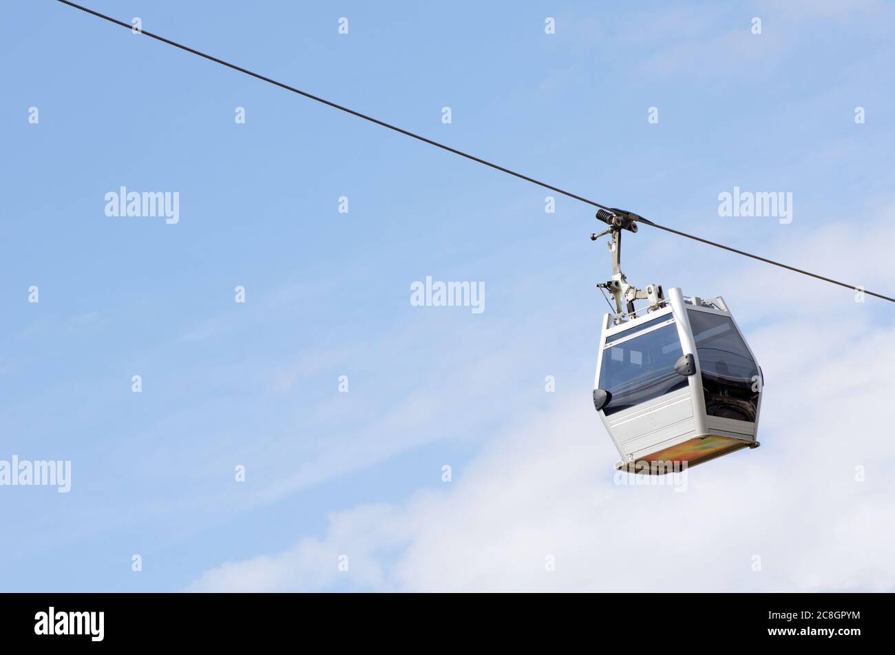 The new cabin cableway against the blue sky Stock Photo - Alamy