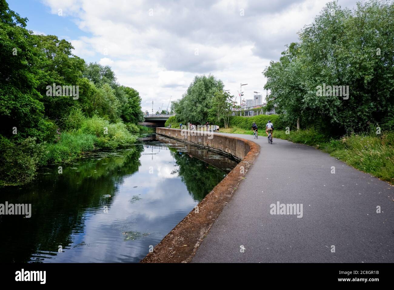 cyclists on towpath of the River Lea running through the Queen Elizabeth Olympic Park in Stratford, Newham UK 2020 Stock Photo