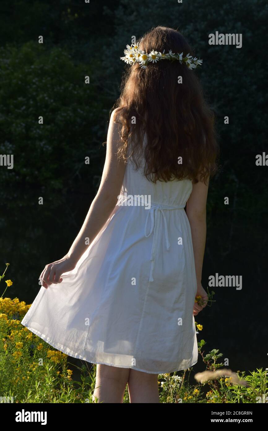 Girl walking in a white dress Stock Photo - Alamy