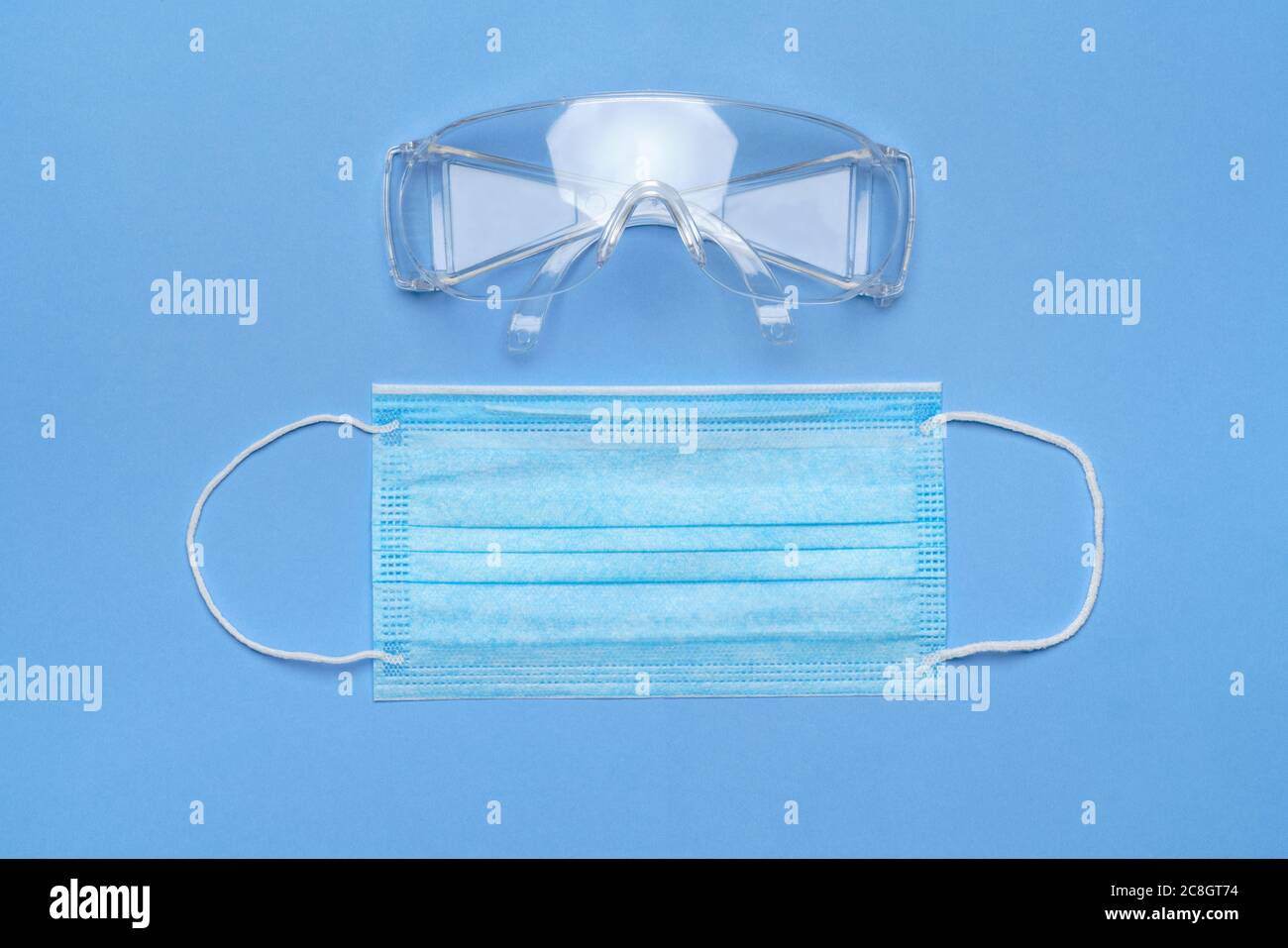 mask and safety glasses for personal protection on blue baclground