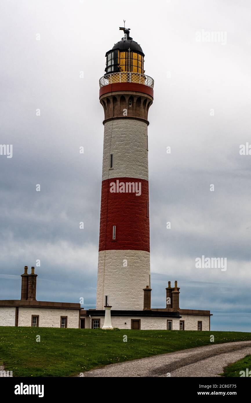 The beautiful Buchan Ness lighthouse, built in 1825, on Moray Firth Coast; Aberdeenshire, Scotland. Scottish sky above the beautiful cliffs of Moray. Stock Photo