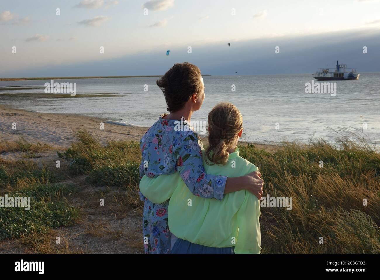 family on the beach watching the sunset Stock Photo