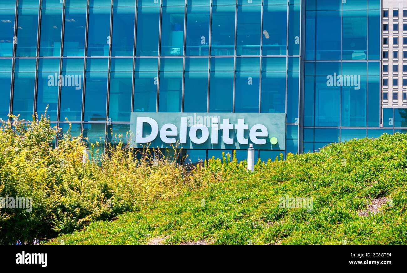 Deloitte Logo Is Seen Above Green Landscaping On Company Office deloitte-office-photos-glassdoor