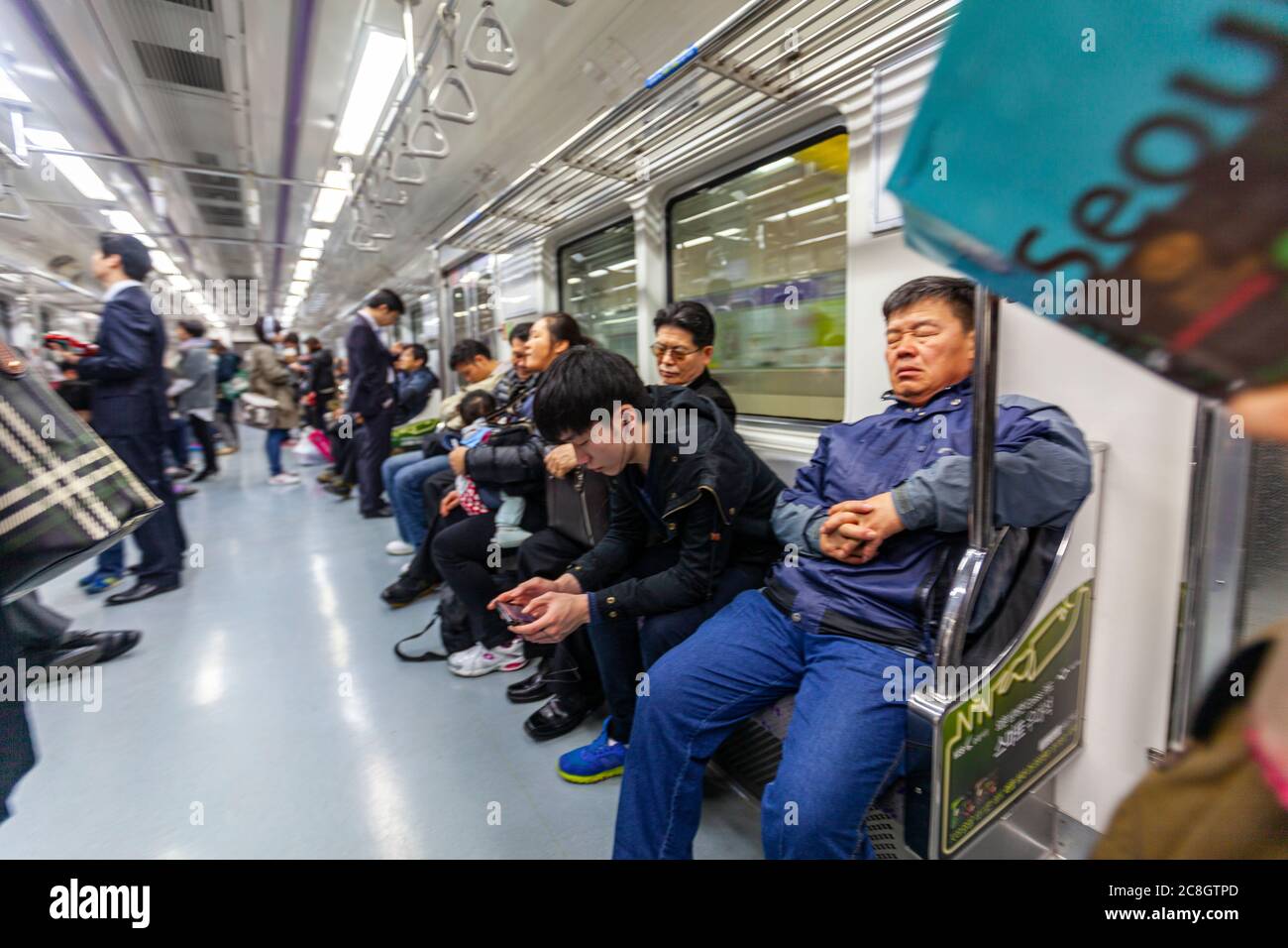 Soul guide book and man sleeping in wagon, Seoul Metropolitan Subway, Seoul, South Korea Stock Photo