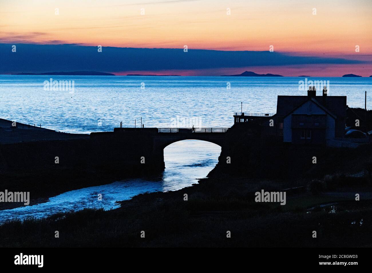 Aberystwyth sunset view looking North in summertime with a view of Llyn Peninsular in the distance. Stock Photo