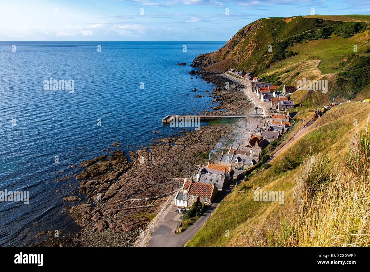 View of the beautiful fishing village of Crovie with the typicals Scottish buildings. Stock Photo