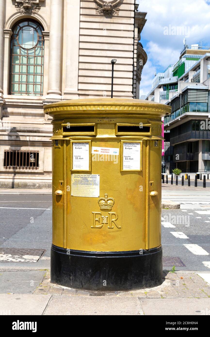 Post box painted gold to celebrate London as the host city of 2012 Olympic and Paralympic Games, Tothill Street, London, UK Stock Photo