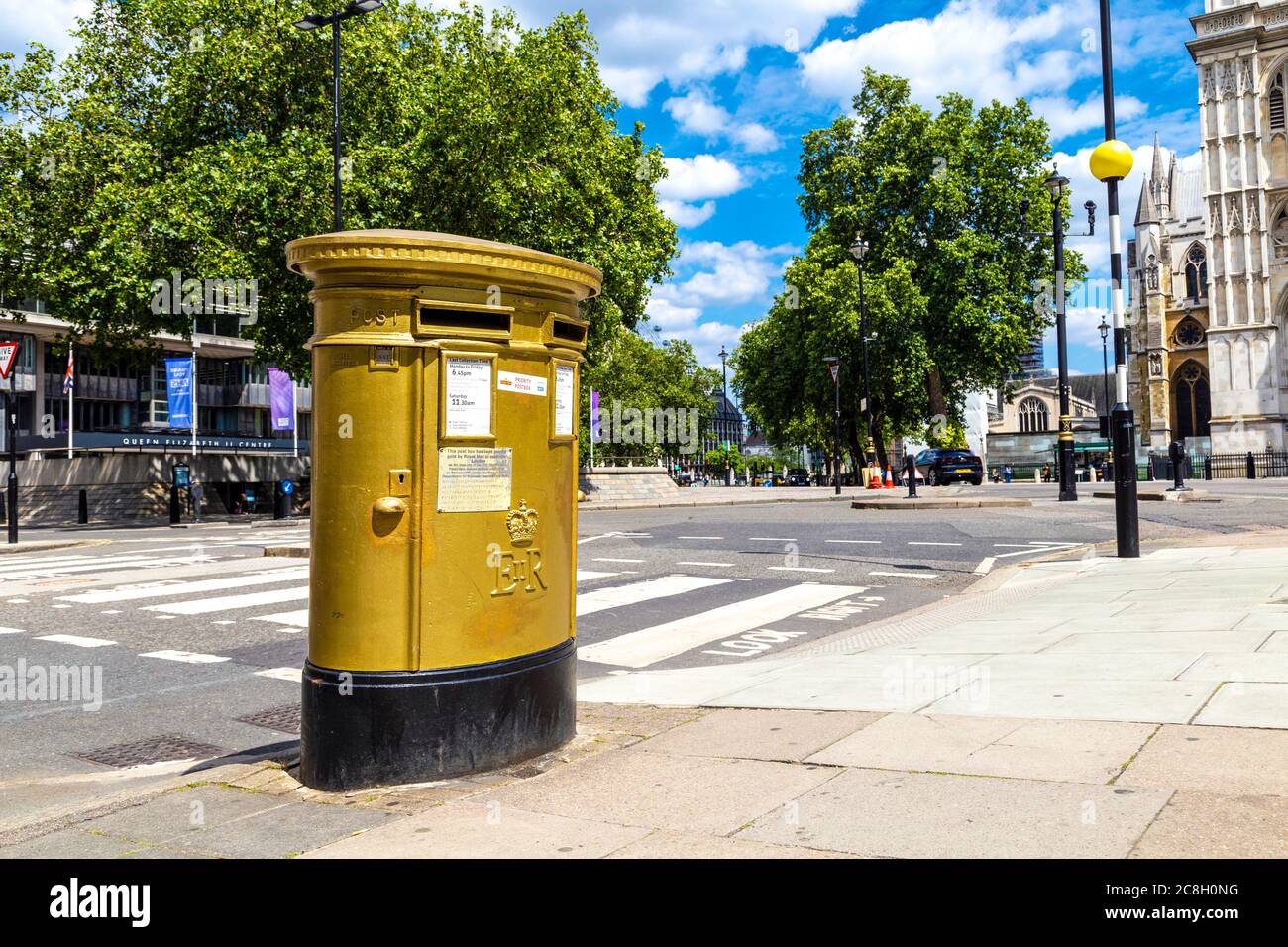 Post box painted gold to celebrate London as the host city of 2012 Olympic and Paralympic Games, Tothill Street, London, UK Stock Photo