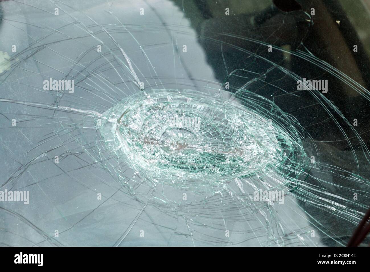 broken car front glass,cracked car front glass,car accident,broken car wind shield,Shattered Windshield after car accident. Stock Photo