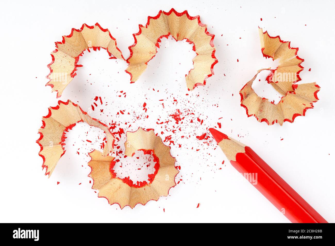 sharpened red pencil with shavings on white paper Stock Photo