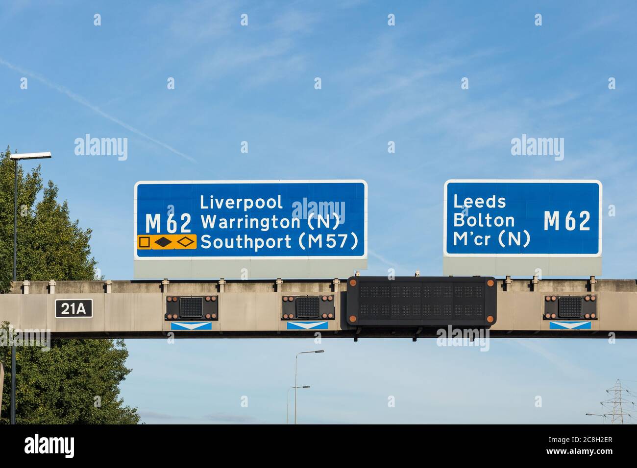 UK motorway sign showing directions to M 62 Liverpool, Warrington, Southport (M57), M 62 Leeds, Bolton, Manchester Stock Photo
