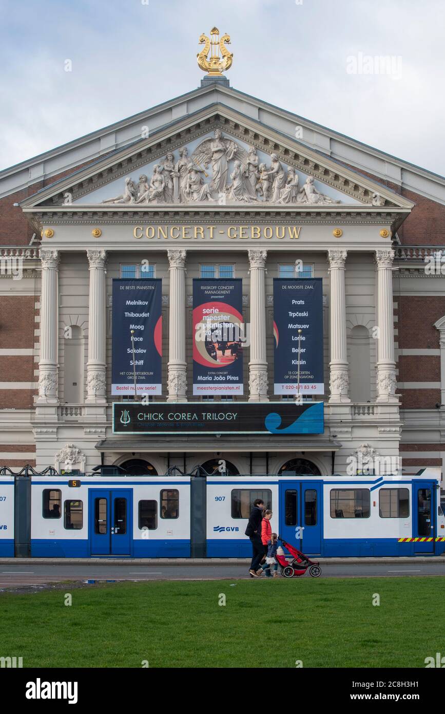 Light rail tram pauses in front of the Royal Concertgebouw music venue, in Amsterdam, Netherlands. Stock Photo