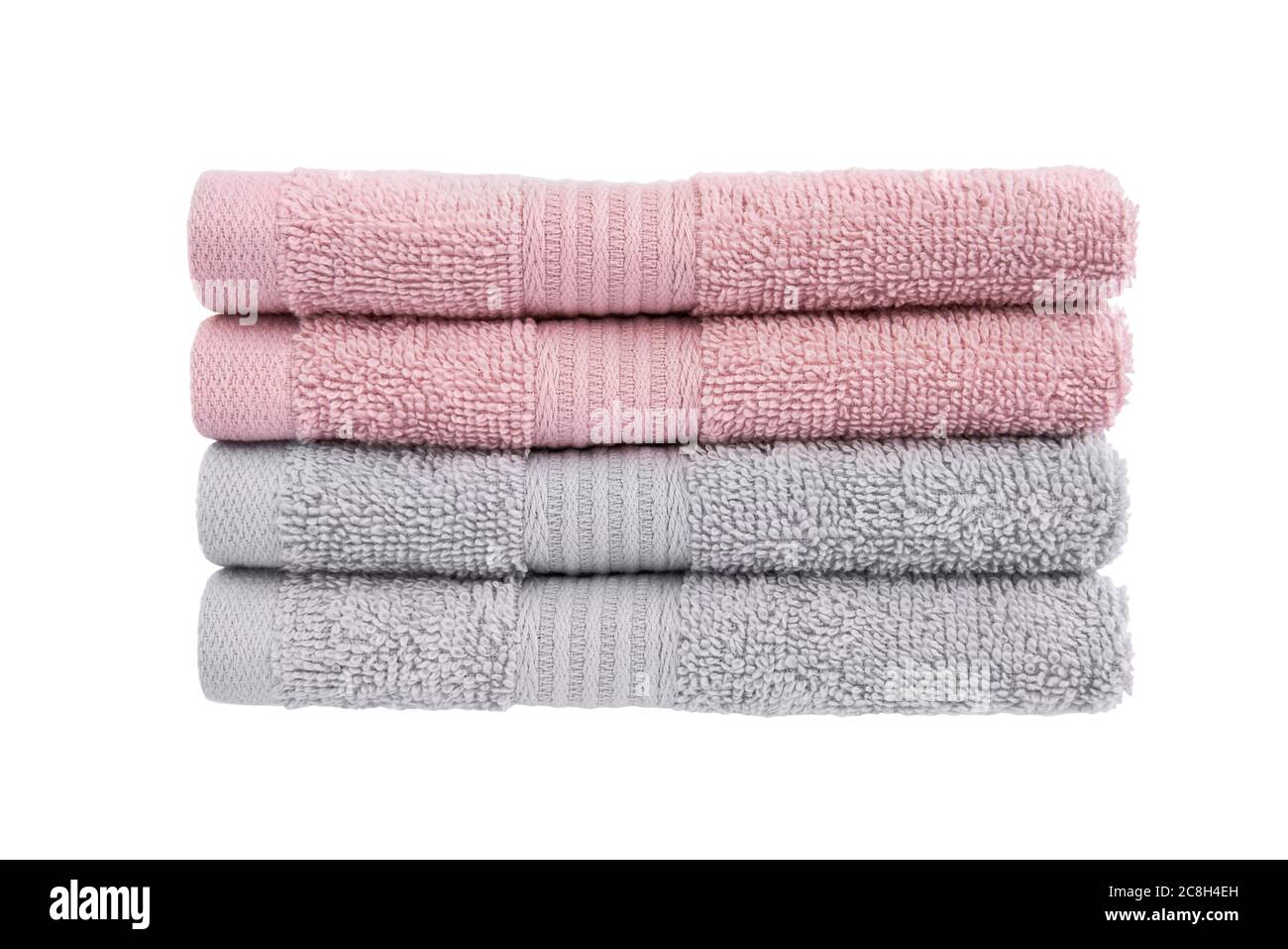 Pink and gray bath towels in stack isolated over white background with