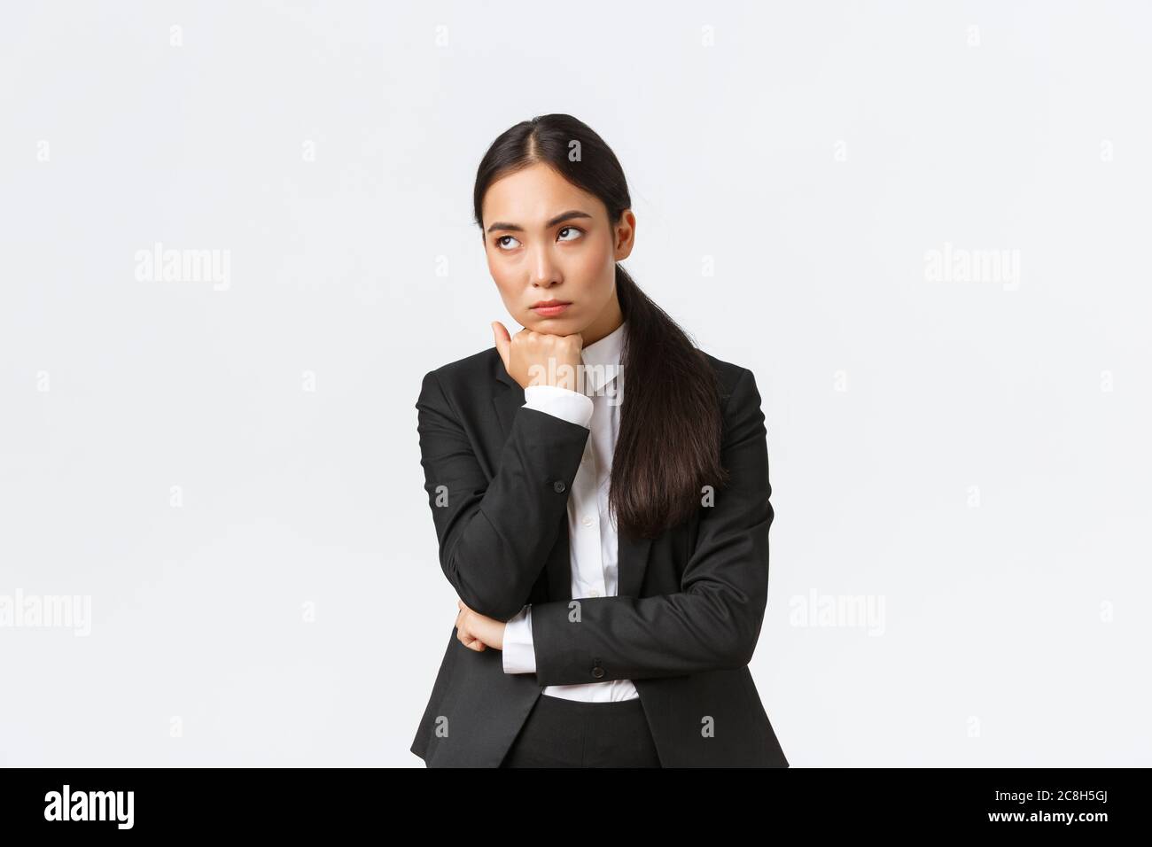 Bored and annoyed female entrepreneur looking unamused away while sitting boring meeting, attend uninteresting office gathering, standing white Stock Photo